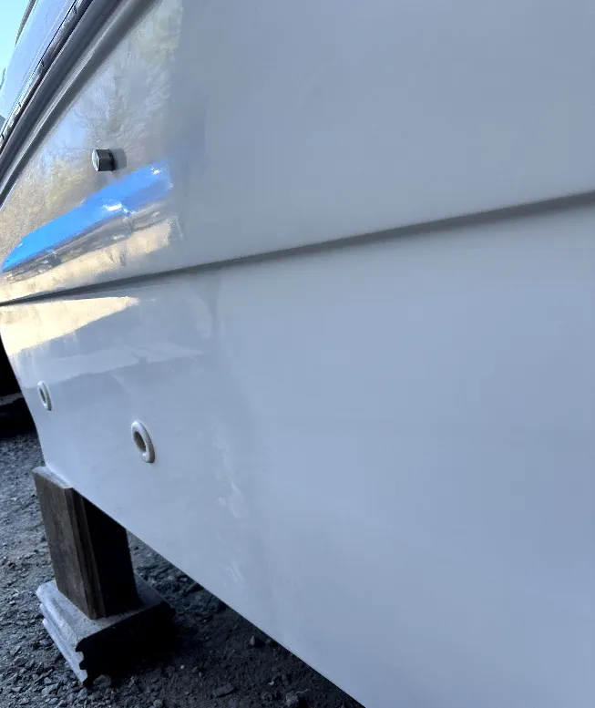 Pristine, high-gloss white boat hull after professional detailing and polishing by True North Detailing Muskoka.