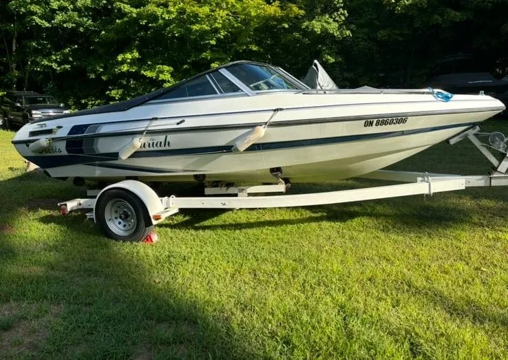 Restored white and blue Mariah boat gleaming on a trailer, showcasing mobile detailing by True North Detailing Muskoka.