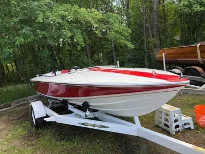 White Donzi speedboat with red stripes on a trailer, showcasing mobile boat detailing in Muskoka.
