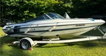 Restored white and blue Mariah boat gleaming on a trailer, showcasing mobile detailing by True North Detailing Muskoka.